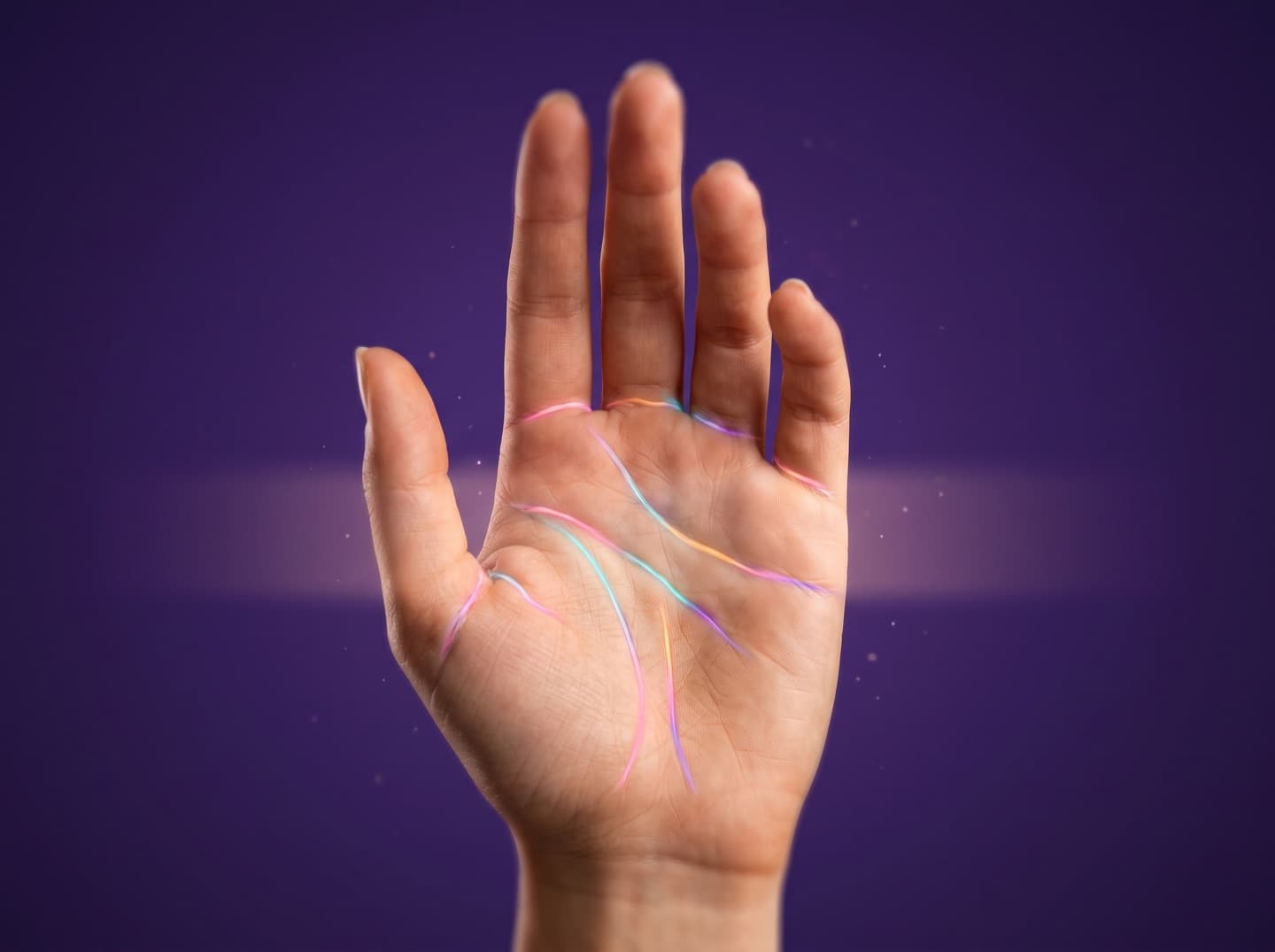 An open palm with the heart, life and fate lines traced in colour